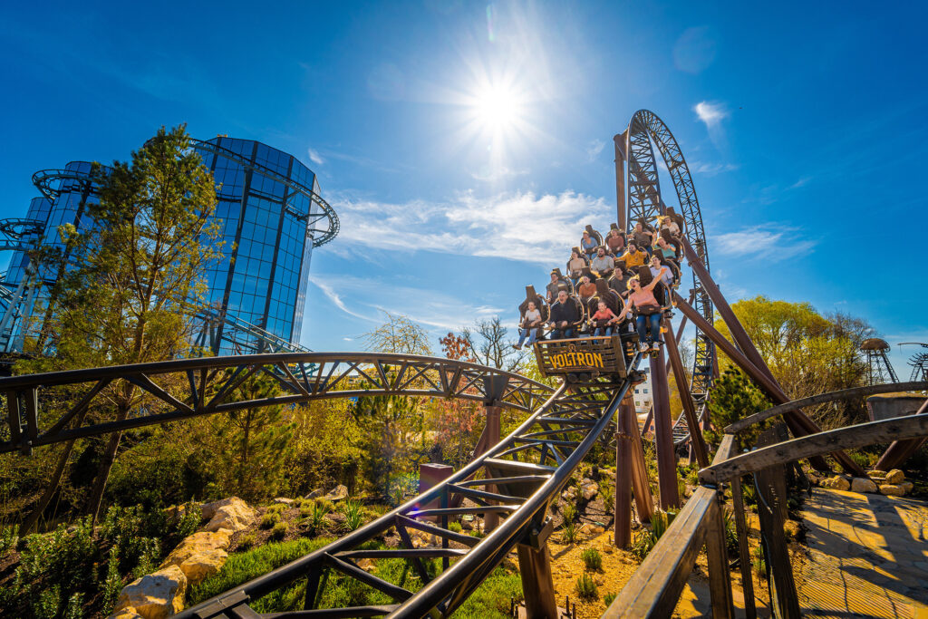 Achterbahn im Europa-Park mit Fahrgästen, die an einem sonnigen Tag fahren.
